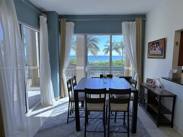 a view of a dining room with furniture window and outside view