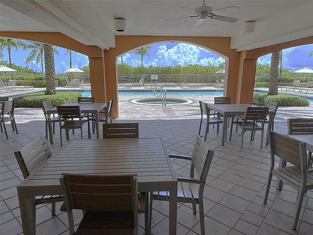 a view of a dining room with furniture large windows and wooden floor