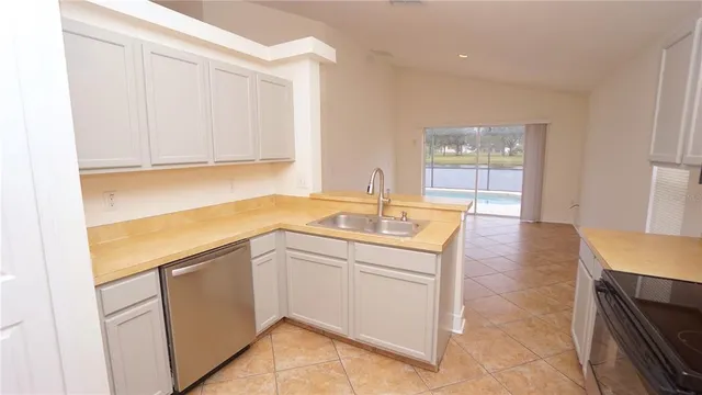 a kitchen with a sink a stove and a microwave