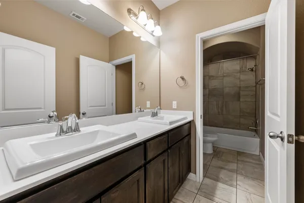 a bathroom with a toilet and a bathtub