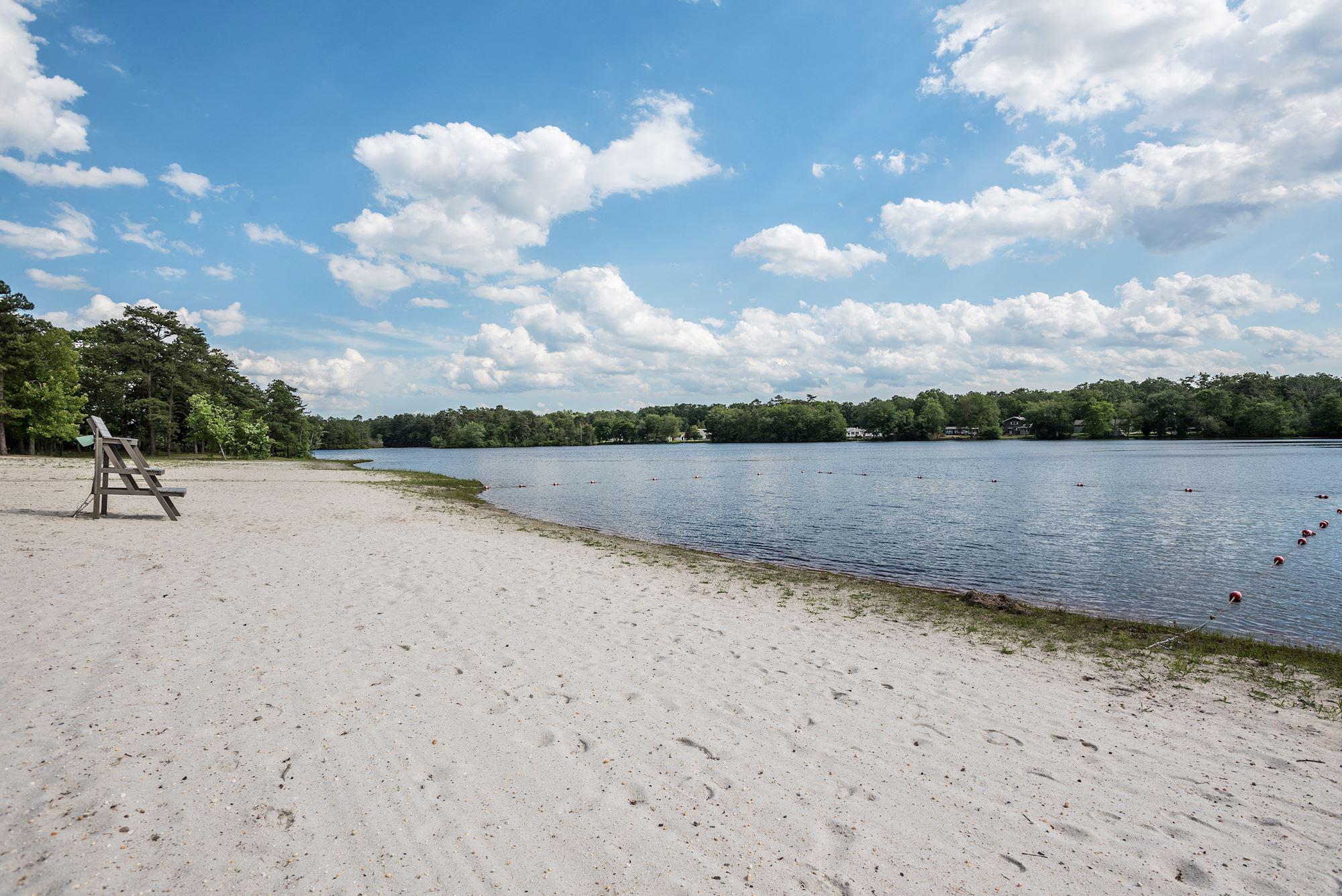 603 New Jersey Road Browns Mills, NJ 08015 - Photo 27 of 28 Serene lakeside retreat with sandy shore.