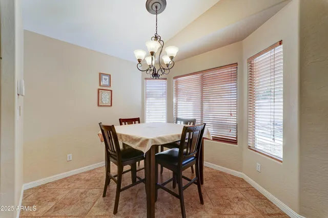 a view of a dining room with furniture and window