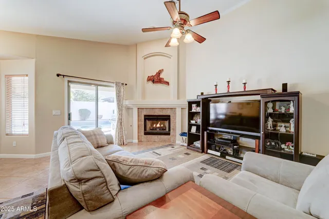 a living room with furniture a flat screen tv and a fireplace