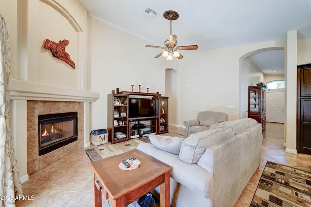 a living room with furniture a fireplace and a flat screen tv
