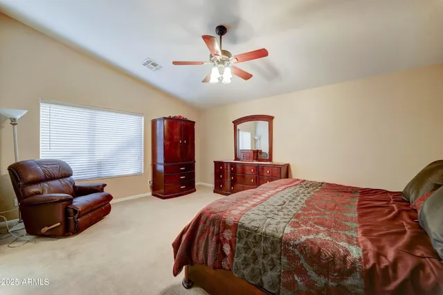 a bedroom with a bed mirror and window