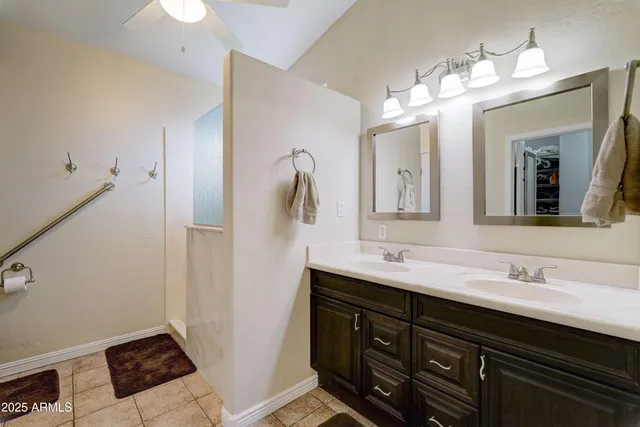 a bathroom with a double vanity sink and a mirror