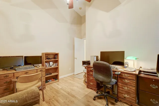 a view of a workspace with furniture and a window