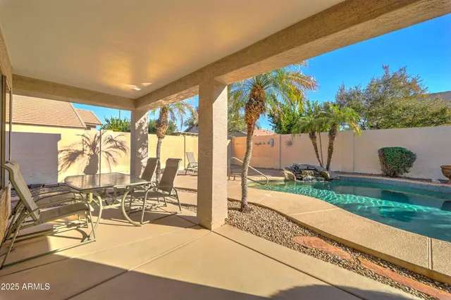 a view of swimming pool with outdoor seating and plants