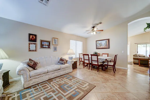 a living room with furniture a rug and a chandelier