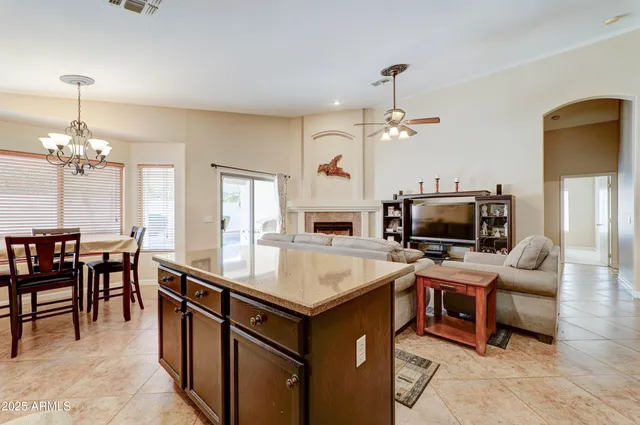 a room with furniture a chandelier a fireplace and a chandelier