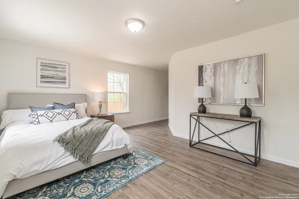 a bedroom with a bed and window
