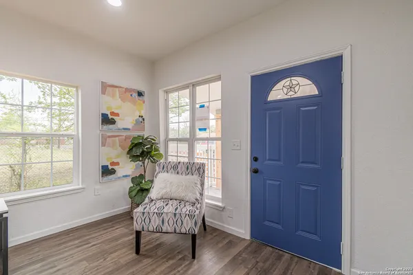 a living room with furniture and wooden floor