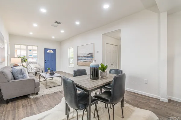 a living room with furniture and wooden floor