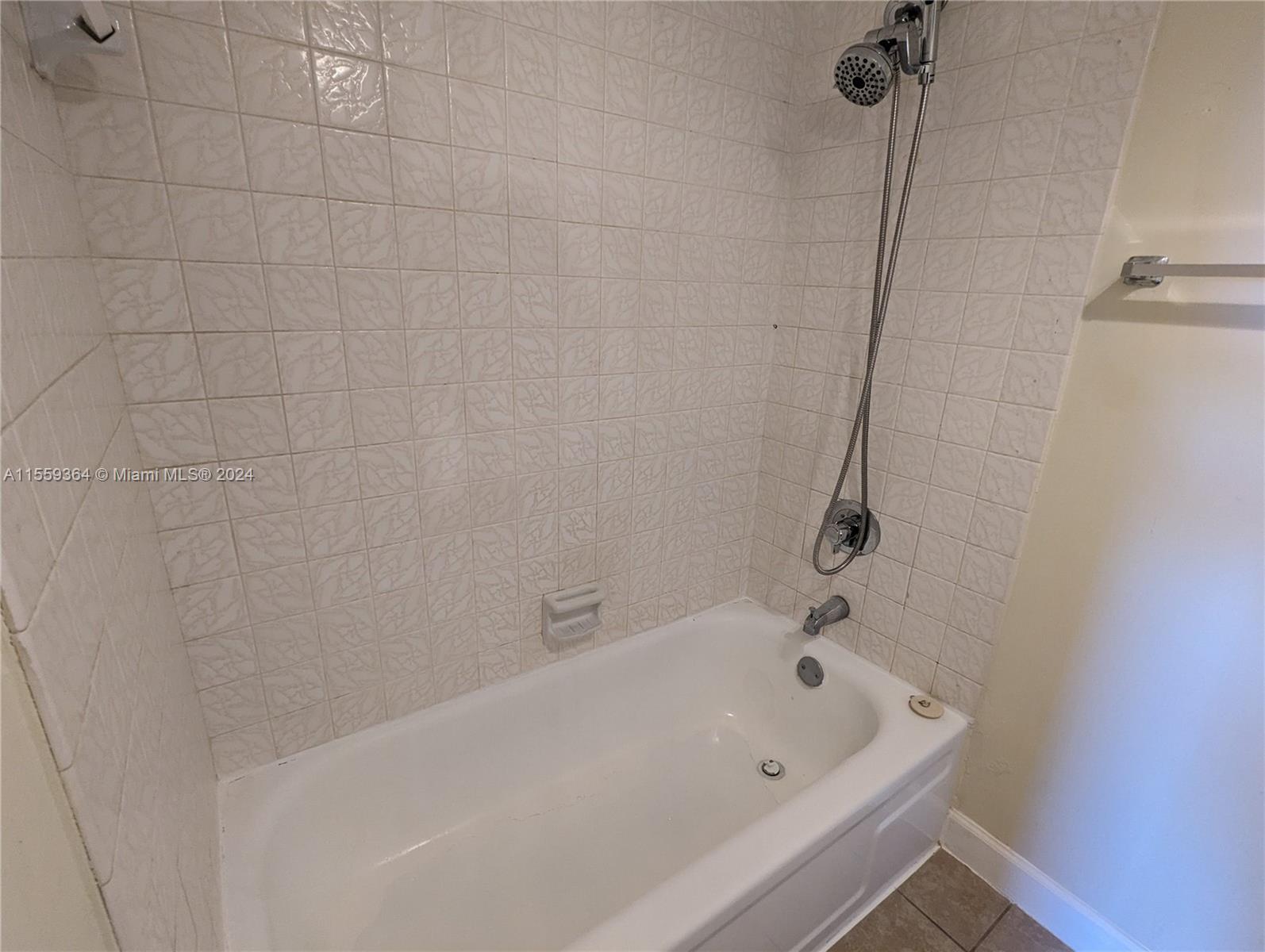 3490 Foxcroft Road, Unit B310 Miramar, FL 33025 - Photo 21 of 34 a white bath tub sitting next to a shower