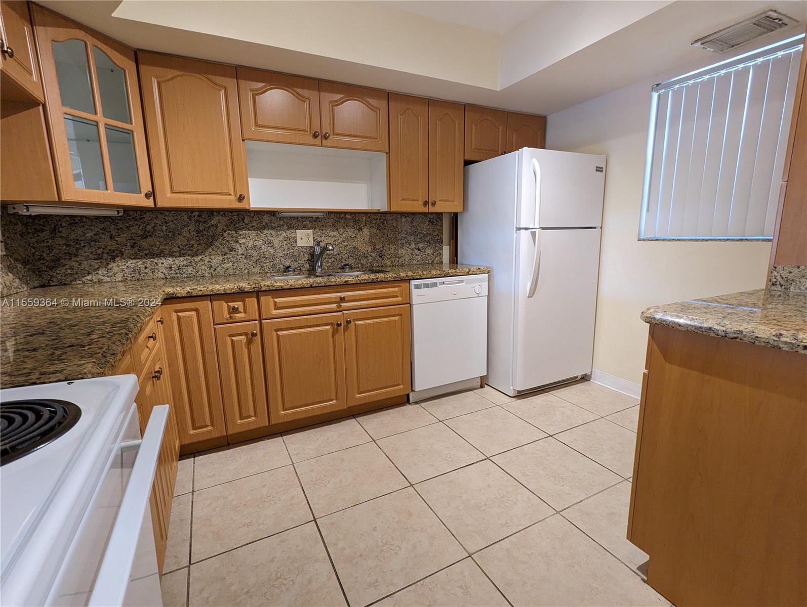 3490 Foxcroft Road, Unit B310 Miramar, FL 33025 - Photo 3 of 34 a kitchen with a refrigerator sink stove and cabinets