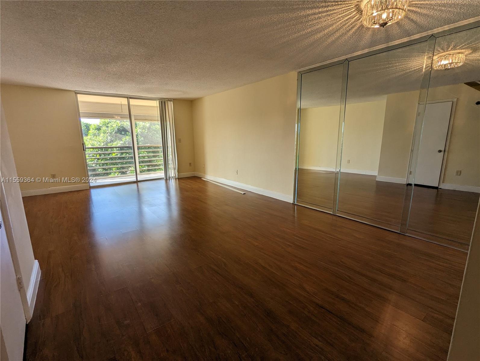 3490 Foxcroft Road, Unit B310 Miramar, FL 33025 - Photo 6 of 34 an empty room with wooden floor and windows