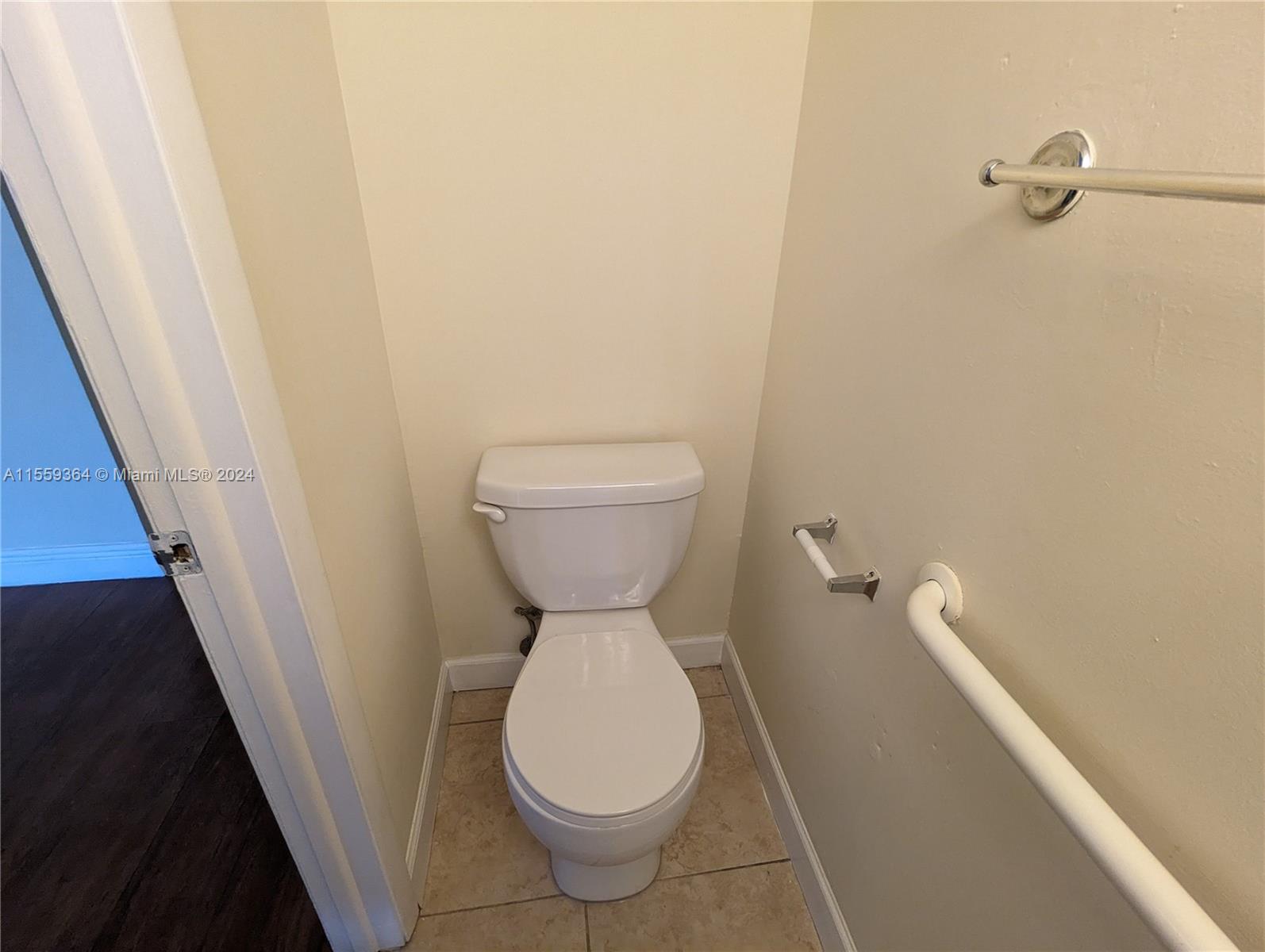 3490 Foxcroft Road, Unit B310 Miramar, FL 33025 - Photo 9 of 34 a bathroom with a toilet and a sink