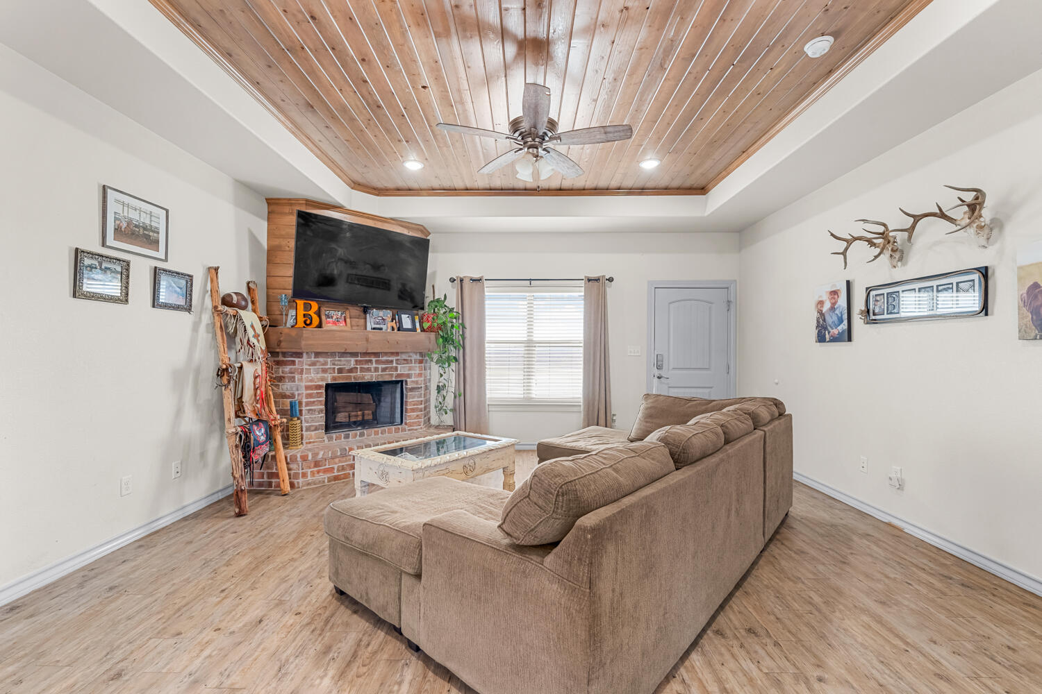 542 Nora Road Wilson, TX 79381 - Photo 15 of 42 a living room with furniture a fireplace and a flat screen tv