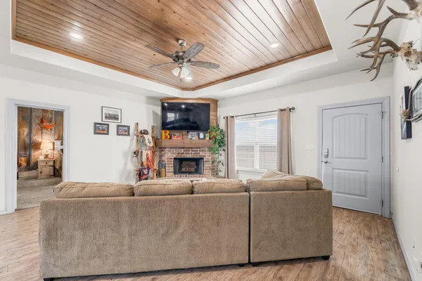 a living room with furniture a fireplace and a flat screen tv