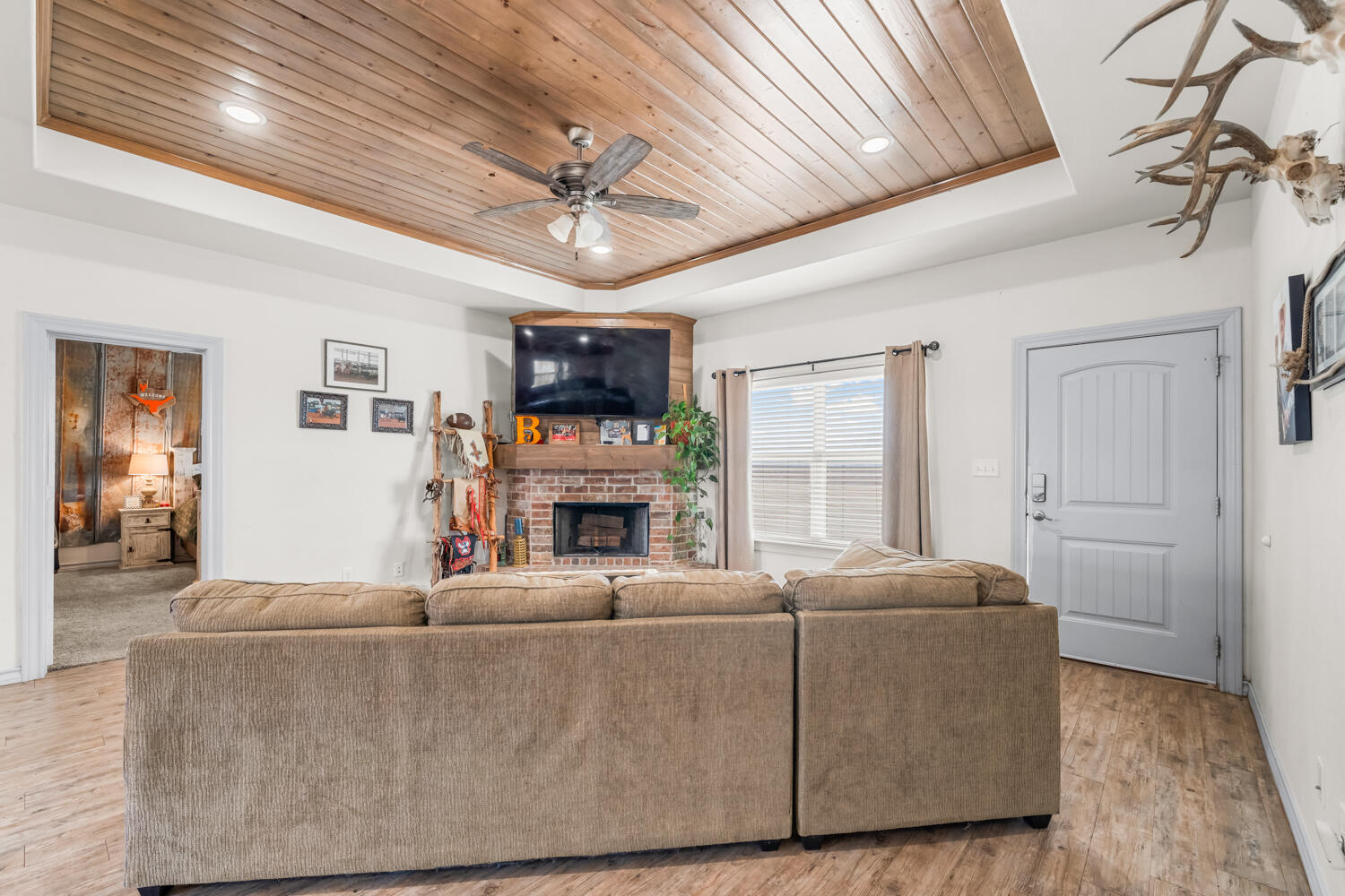 542 Nora Road Wilson, TX 79381 - Photo 16 of 42 a living room with furniture a fireplace and a flat screen tv