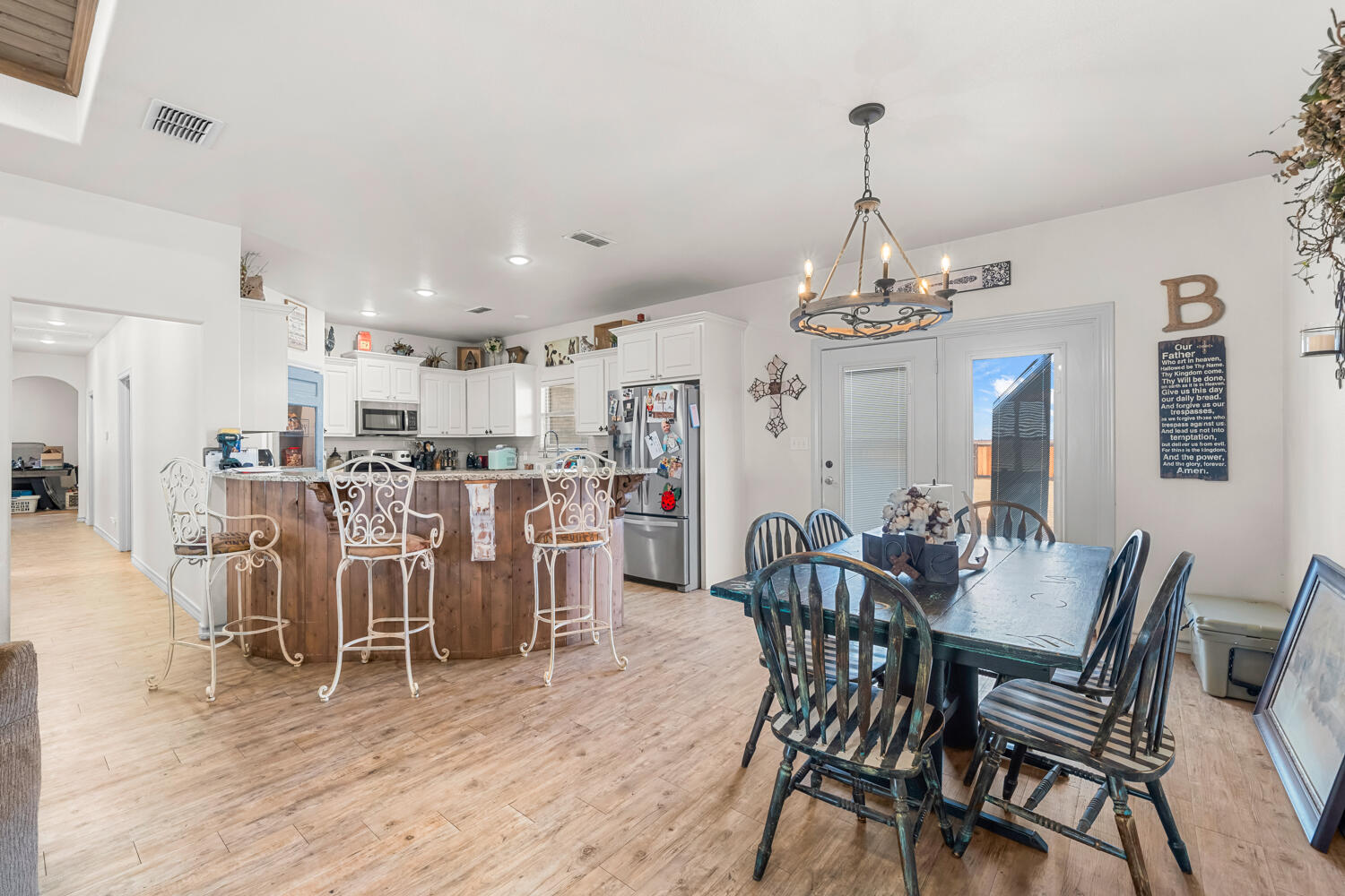 542 Nora Road Wilson, TX 79381 - Photo 19 of 42 a view of a dining room with furniture and chandelier
