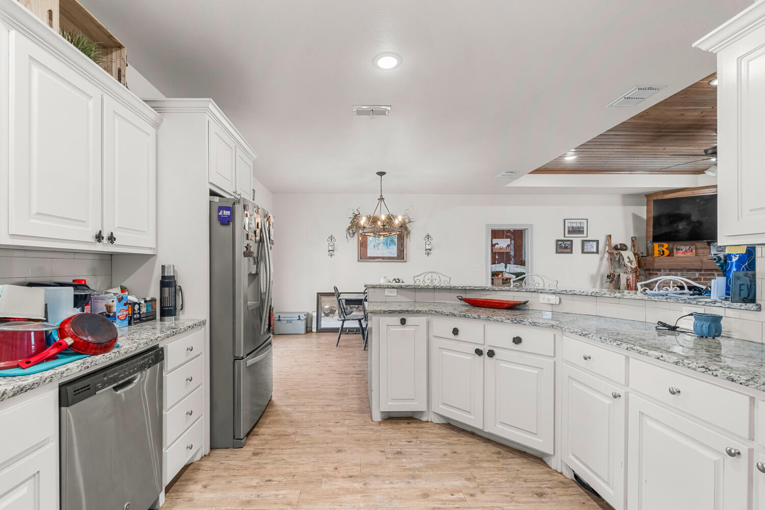 542 Nora Road Wilson, TX 79381 - Photo 23 of 42 a kitchen with granite countertop a sink stove refrigerator and cabinets