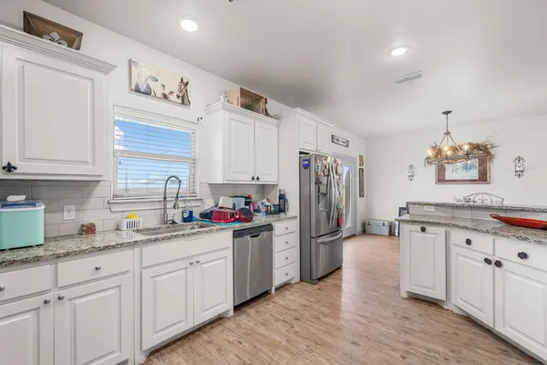a kitchen with refrigerator and cabinets