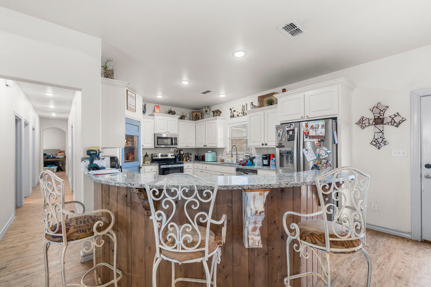 542 Nora Road Wilson, TX 79381 - Photo 25 of 42 a kitchen with stainless steel appliances granite countertop a table chairs and a refrigerator