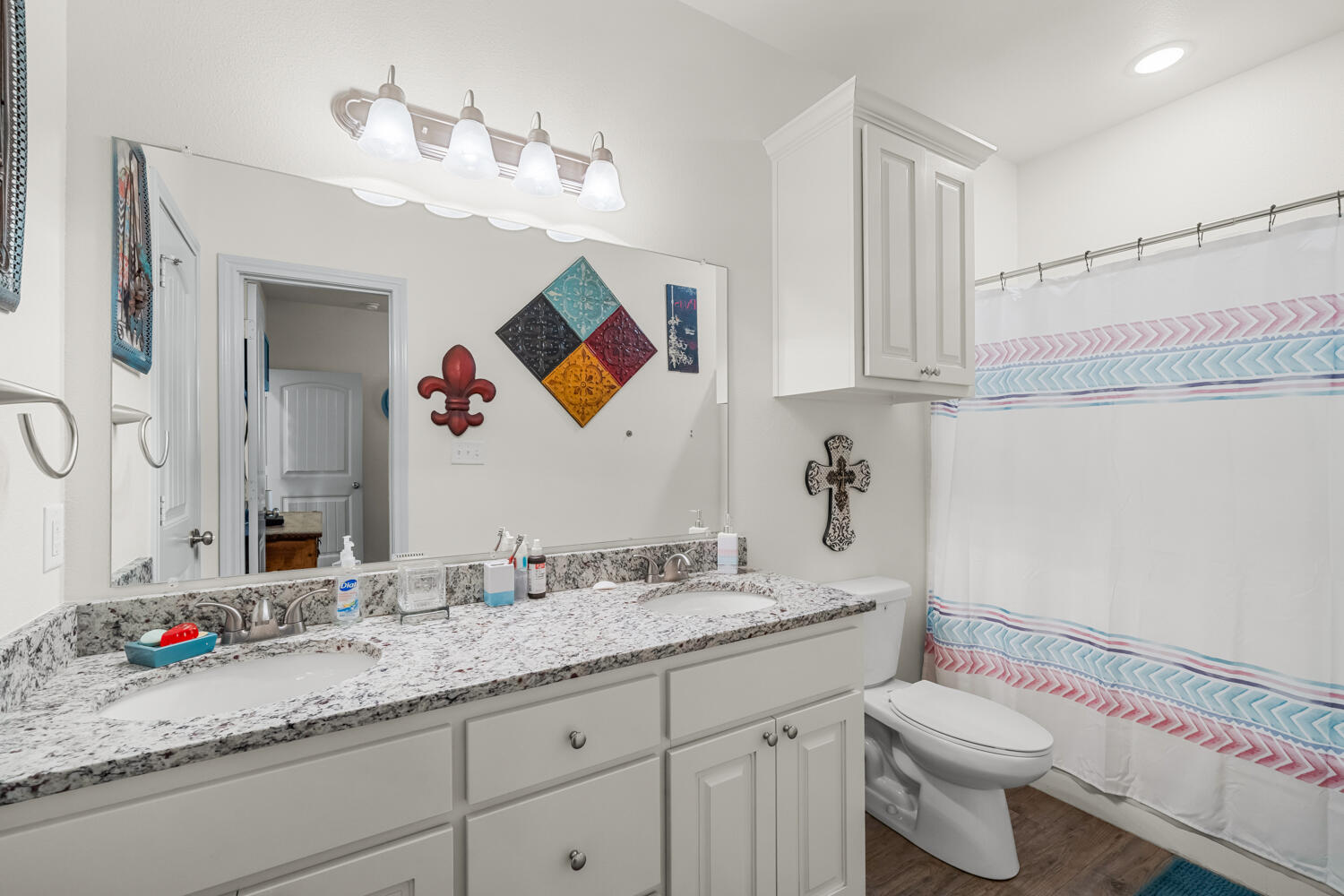 542 Nora Road Wilson, TX 79381 - Photo 31 of 42 a bathroom with a granite countertop sink mirror vanity and toilet