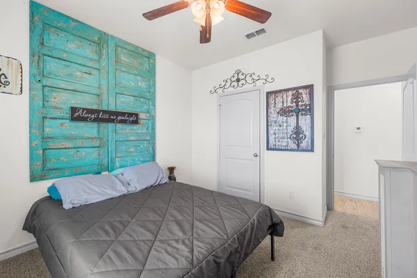 a bed sitting in a bedroom next to a window