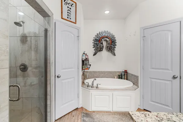 a bathroom with a tub and a shower