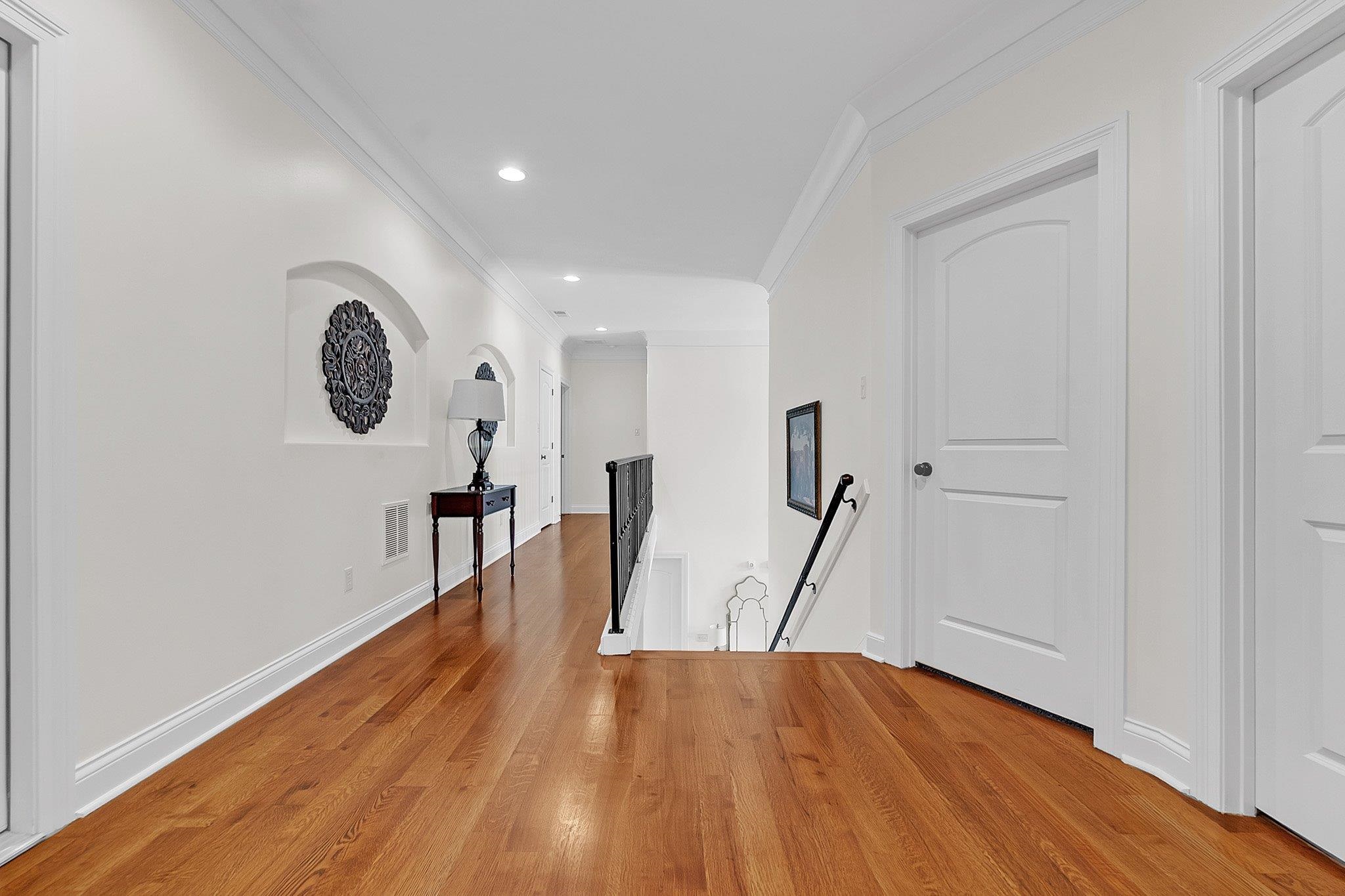 3246 North Hartwell Ridge Drive Collierville, TN 38017 - Photo 28 of 40 Hardwood flooring extending through a brightly lit hallway