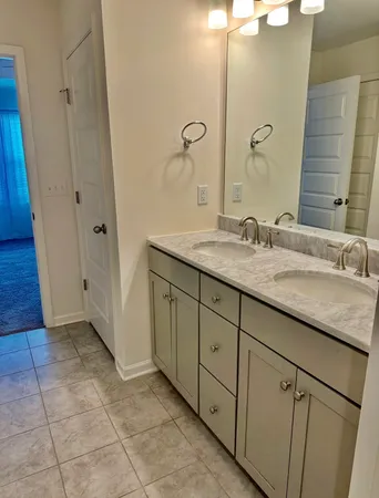 a white toilet sitting next to a white wall