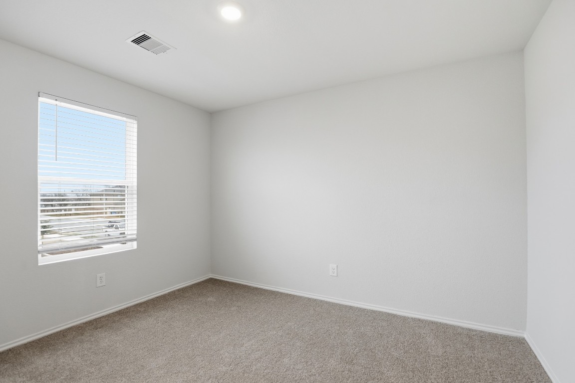 427 Sickle Loop Kyle, TX 78640 - Photo 13 of 39 Spare room featuring carpet and baseboards