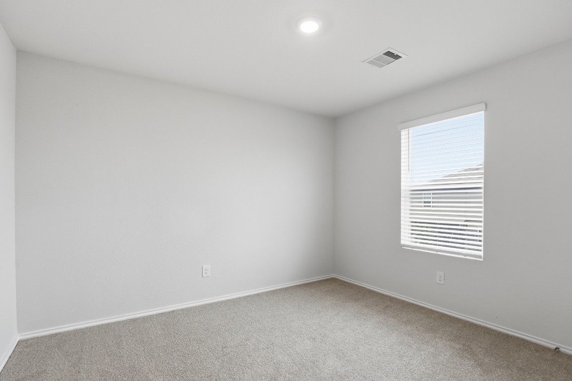 427 Sickle Loop Kyle, TX 78640 - Photo 15 of 39 Carpeted spare room featuring baseboards
