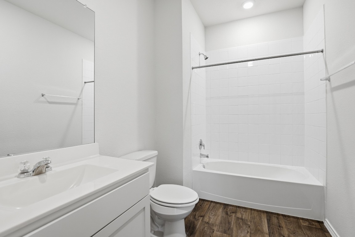 427 Sickle Loop Kyle, TX 78640 - Photo 18 of 39 Bathroom with shower / tub combination, vanity, dark wood-style floors, and recessed lighting