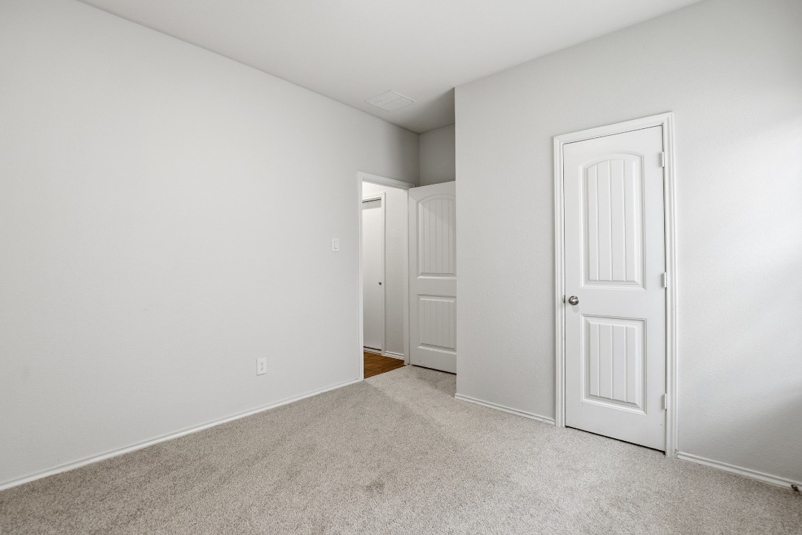 427 Sickle Loop Kyle, TX 78640 - Photo 22 of 39 Unfurnished bedroom featuring light colored carpet and baseboards
