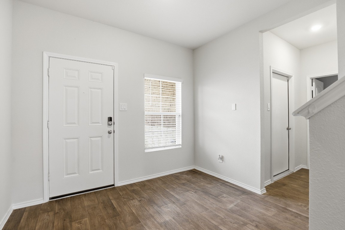 427 Sickle Loop Kyle, TX 78640 - Photo 23 of 39 Foyer entrance with dark wood-style flooring and baseboards