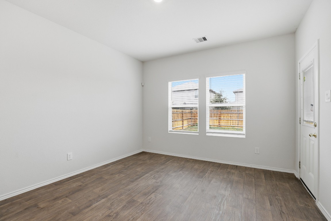 427 Sickle Loop Kyle, TX 78640 - Photo 26 of 39 Unfurnished room featuring dark wood-type flooring and baseboards