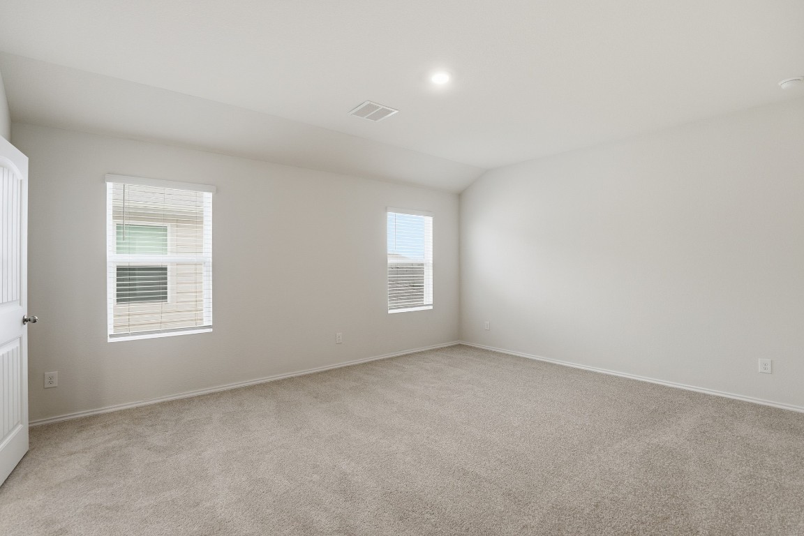 427 Sickle Loop Kyle, TX 78640 - Photo 3 of 39 Empty room with light colored carpet and lofted ceiling