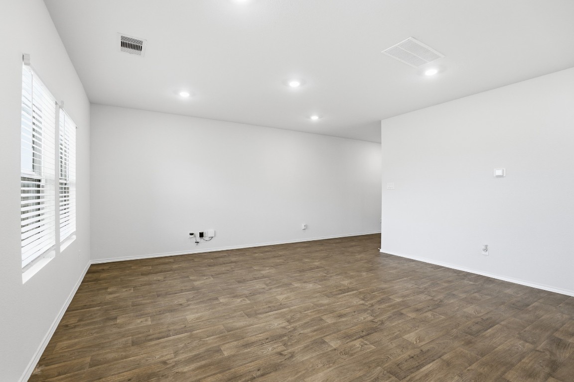427 Sickle Loop Kyle, TX 78640 - Photo 32 of 39 Spare room featuring dark wood-style floors and recessed lighting