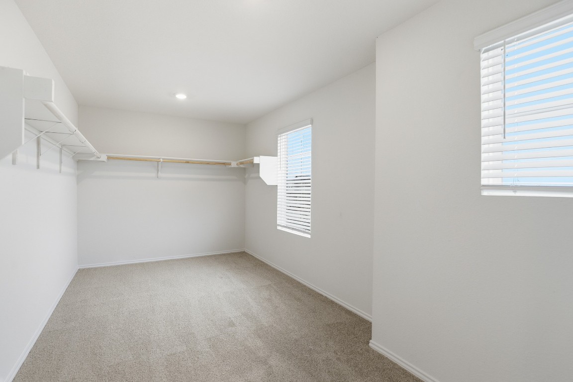 427 Sickle Loop Kyle, TX 78640 - Photo 6 of 39 Walk in closet featuring light colored carpet