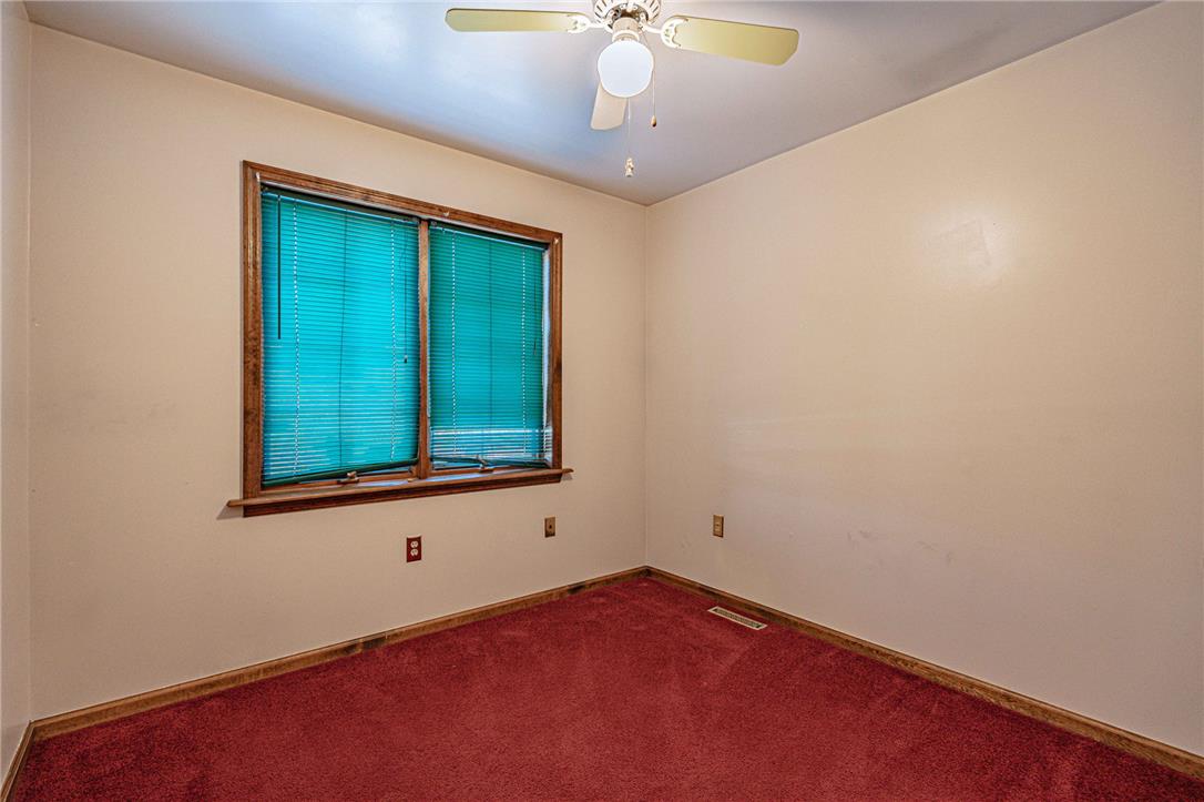 652 Old State Road Oley, PA 19547 - Photo 28 of 54 A well-lit bedroom space featuring plush carpeting and a ceiling fan for comfort.