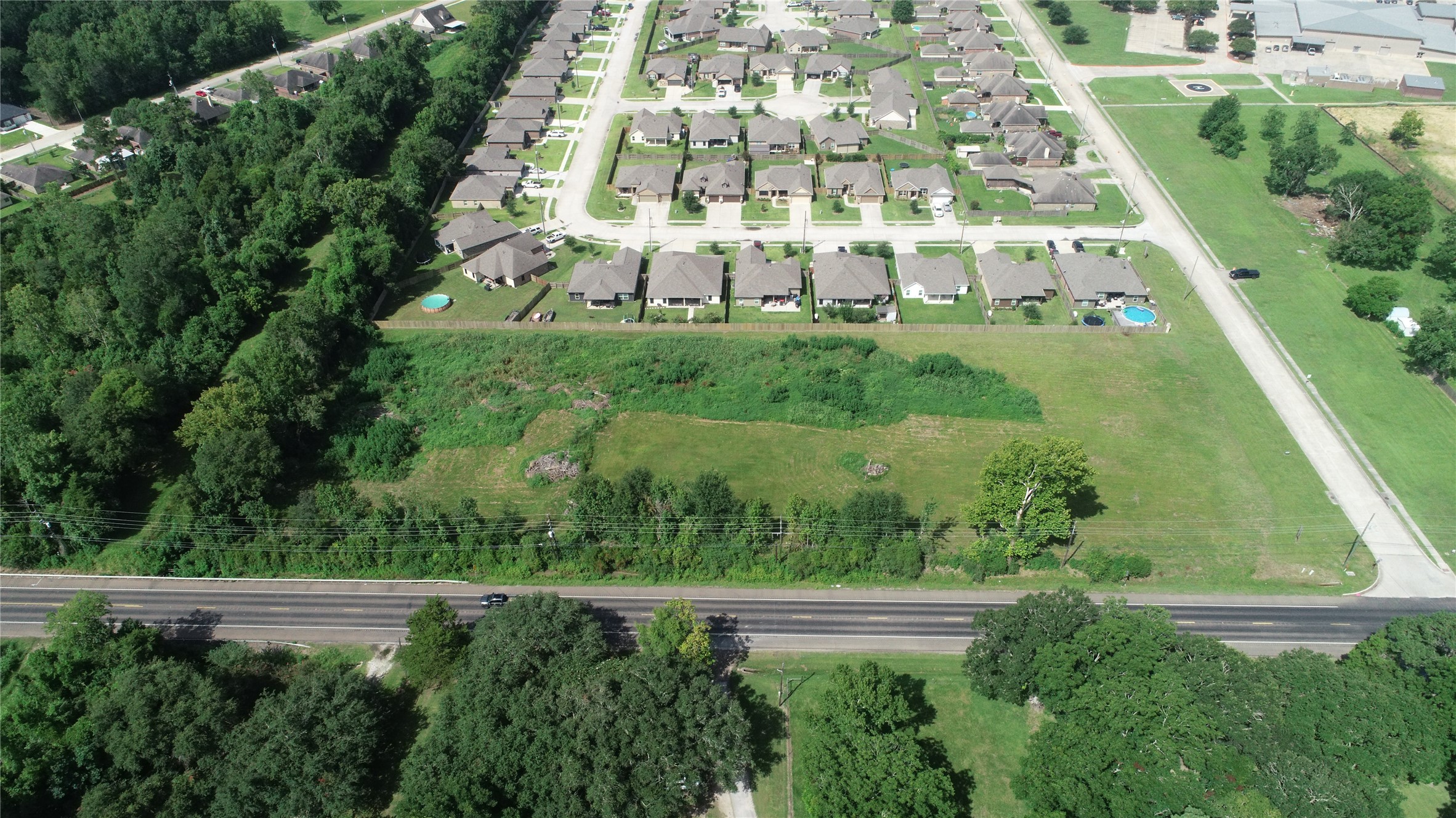 0 South Winfree Street Dayton, TX 77535 - Photo 2 of 14 a view of building with yard