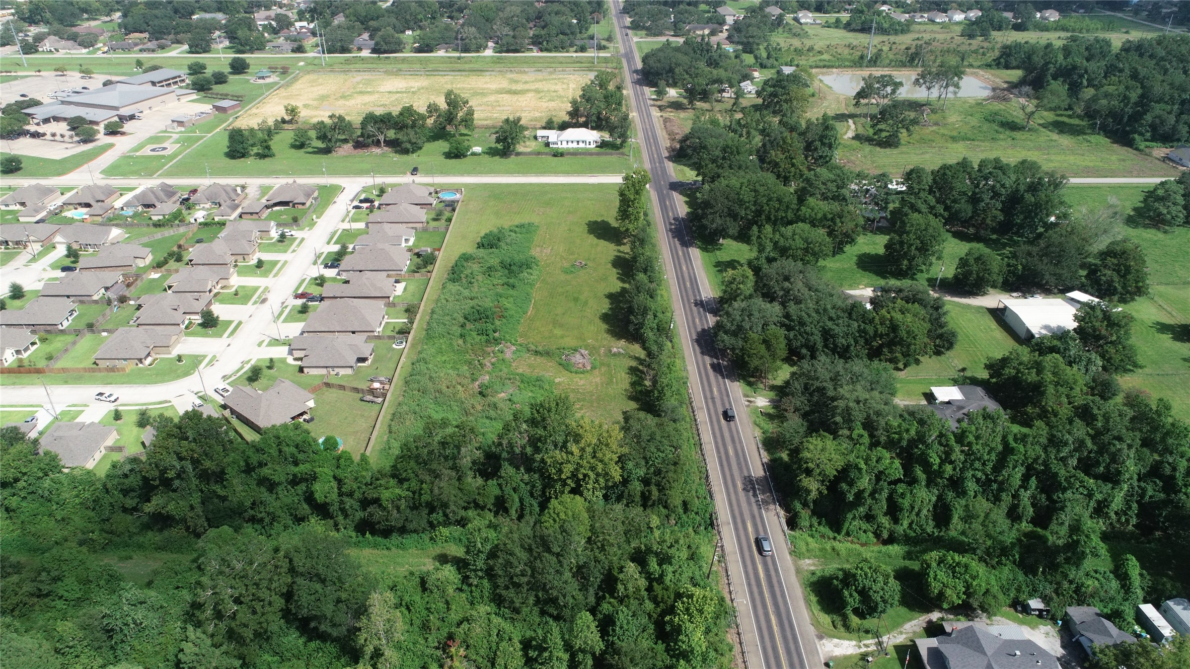 0 South Winfree Street Dayton, TX 77535 - Photo 3 of 14 an aerial view of residential houses with outdoor space and trees