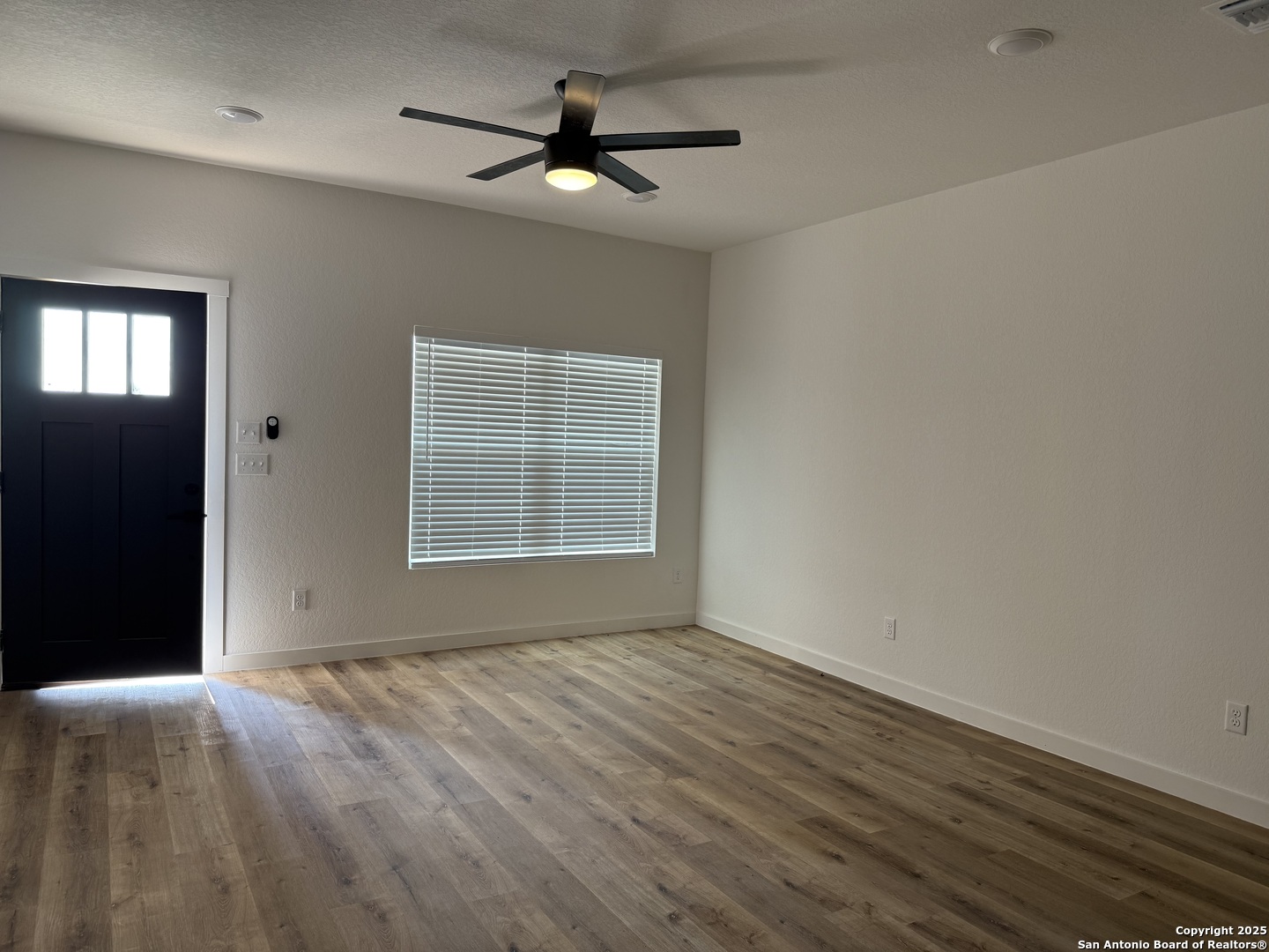 2105 Vista Rosa Three Rivers, TX 78071 - Photo 2 of 14 wooden floor in an empty room with a window