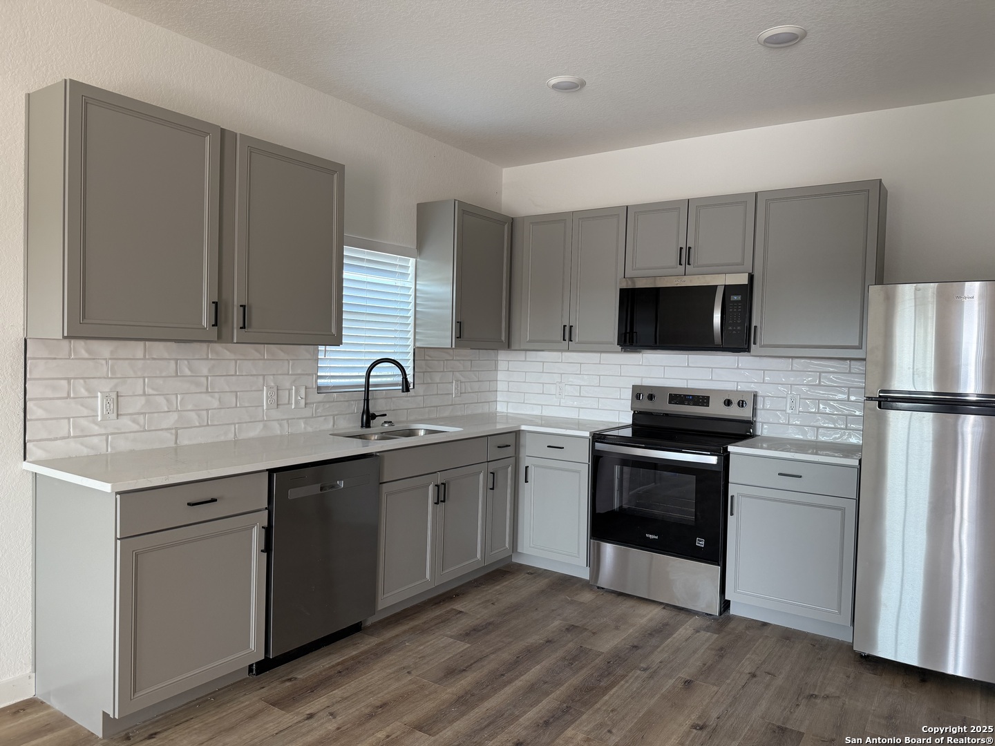 2105 Vista Rosa Three Rivers, TX 78071 - Photo 3 of 14 a kitchen with a sink cabinets stainless steel appliances and a window