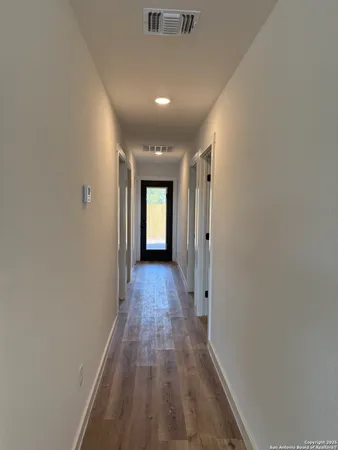 a view of hallway with wooden floor