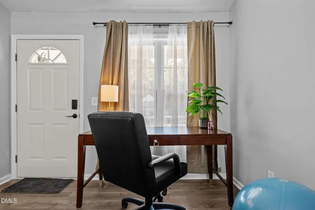 a view of a workspace room with furniture and wooden floor