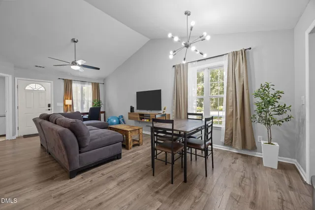 a view of a dining room with furniture and wooden floor